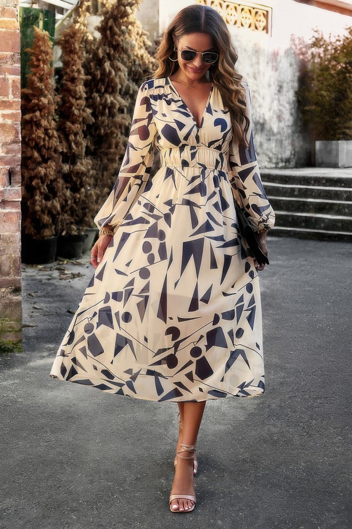 Model in abstract print v neck maxi dress by SplendorAmoris, featuring boho long sleeve a line with high waist for elegant flow