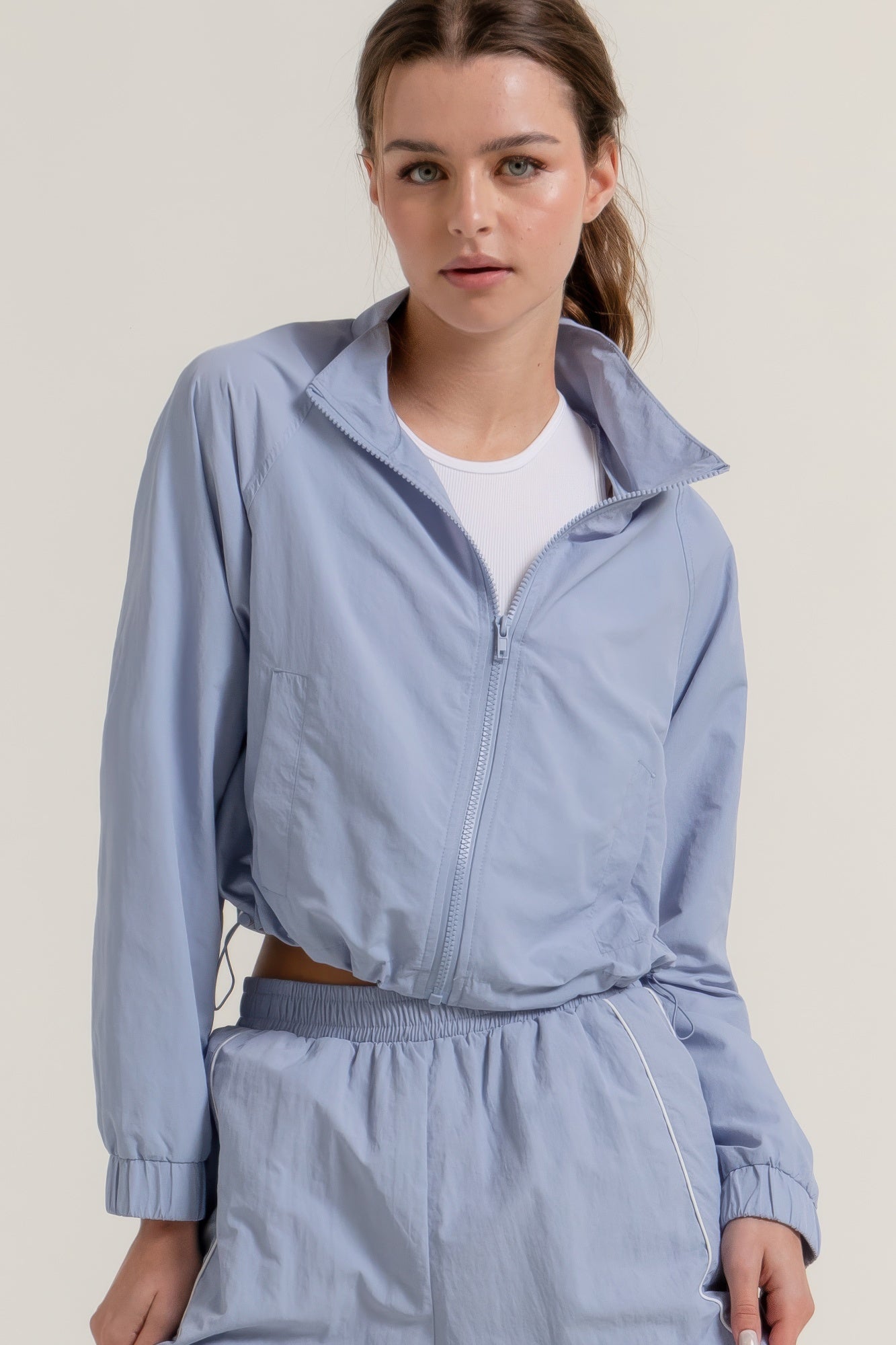 Women's cropped active anorak jacket with long sleeves, front zipper, stand collar, cinch hem, and sporty outline - SplendorAmoris